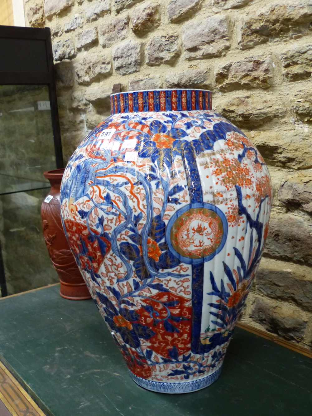 A LARGE JAPANESE IMARI RIBBED OVOID JAR PAINTED WITH CHERRY TREES IN BLOSSOM ALTERNATING WITH PHOENI - Image 4 of 10