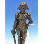 A NELSON CAST IRON DOOR STOP, HE STANDS WITH HIS LEFT HAND ON HIS HIP AND A DRAWN SWORD IN HIS