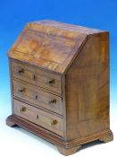 A GEORGIAN WALNUT MINIATURE BUREAU, THE FALL AND THREE GRADED LONG DRAWER FRONTS LINE INLAID ABOVE