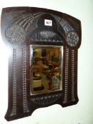 A BEVELLED GLASS RECTANGULAR MIRROR WITHIN A RUSSIAN ART NOUVEAU MAHOGANY FRAME CHIP CARVED WITH