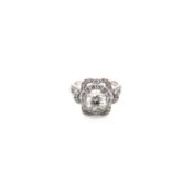 A VICTORIAN STYLE DIAMOND SET CLUSTER RING , THE CENTRAL OLD CUT DIAMOND RAISED IN FOUR CLAW SETTING