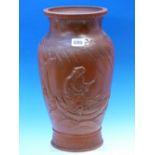A CHINESE RED WARE VASE MOULDED IN RELIEF WITH A SAGE PUNTING HIS BOAT BELOW WILLOW TREES, SQUARE