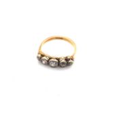 AN ANTIQUE 18ct YELLOW GOLD AND GRADUATED OLD CUT DIAMOND HALF HOOP RING. THE SHANK STAMPED 18ct.