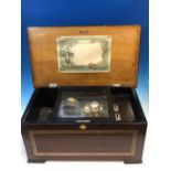 AN ANTIQUE MUSIC BOX PLAYING TEN AIRS ON A 14cms. COMB, DRUM AND THREE BELLS, THE CASE WITH PRINTED