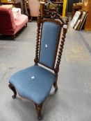 A VICTORIAN MAHOGANY NURSING CHAIR, THE BLUE VELVET BACK PANEL BETWEEN SPIRAL TURNED COLUMNS, THE