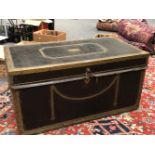 A BRASS CLOSE NAILED BLACK LEATHER COVERED CAMPHOR WOOD TRUNK WITH BRASS EDGING AND WITH TWO