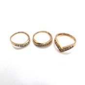 THREE 9ct HALLMARKED GOLD CUBIC ZIRCONIA DRESS RINGS. TWO WISHBONE RINGS AND ONE CHANNEL SET HALF
