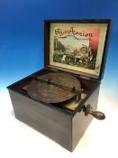 A SYMPHONIUM PLAYING A 19.5cms. DISC WITHIN AN EBONISED BOX WITH FLORAL PRINTED LID. THE BOX. W 27 x