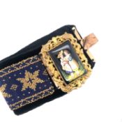 AN ANTIQUE HAND ENAMELLED PANEL AND WOVEN BEAD WORK CUFF BRACELET. LENGTH 17cms. OVERALL PANEL