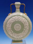 A ROYAL WORCESTER TWO HANDLED MOON FLASK, THE PALE GREEN CELADON BODY OVER DECORATED IN WHITE WITH