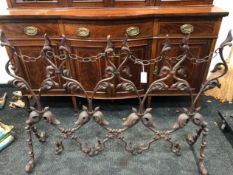 A WROUGHT IRON SCREEN, THE CHAIN LINKED TOP OVER THREE FOLIATE OVALS AND PAIRS OF FEET TO EACH