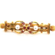 A VICTORIAN YELLOW GOLD DIAMOND RUBY AND PEARL BAR BROOCH . INDISTINCTLY MARKED AND ASSESSED AS ??ct
