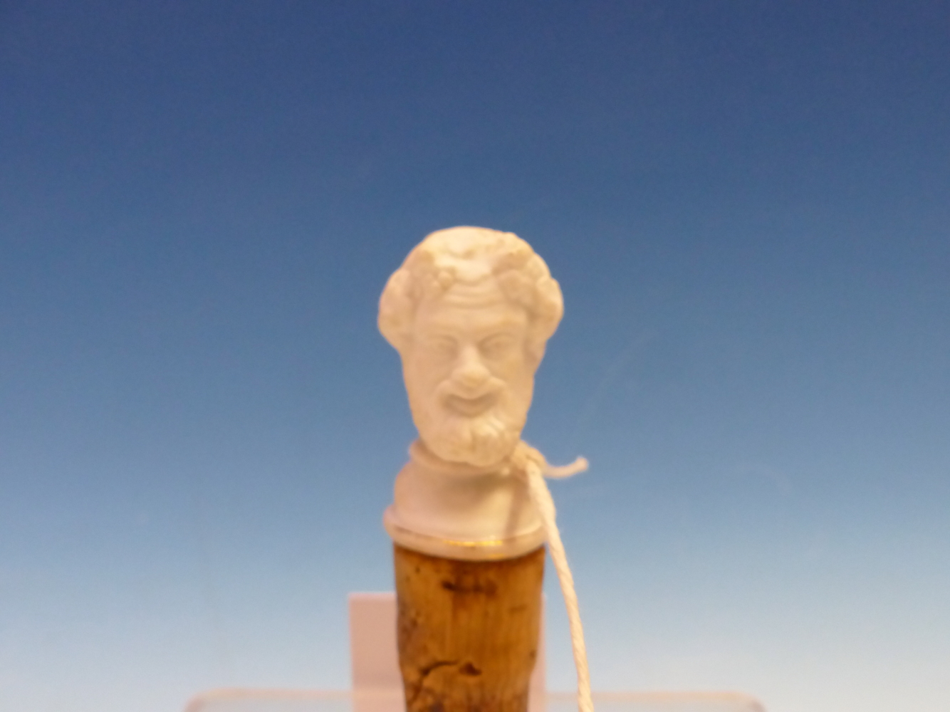 A EUROPEAN BISCUIT PORCELAIN HEAD OF BACCHUS ON A CORK BASE AS A BOTTLE STOPPER. H 8cms. - Image 2 of 3