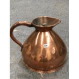 A VICTORIAN COPPER SPIRIT MEASURE, THE JUG WITH A BRAZED SEAM BELOW THE HANDLE. H 35cms.