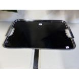 AN ART DECO BLACK PLASTIC TRAY WITH CHROME RIM AND HANDLES. 58.5 x 37.5cms.