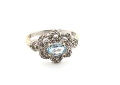 A HALLMARKED 9ct WHITE GOLD AQUAMARINE AND DIAMOND DRESS RING. FINGER SIZE S. WEIGHT 3.79grms.