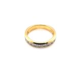 A DIAMOND CHANNEL SET THREE QUARTER ETERNITY RING. THE CHANNEL WITH FOURTEEN ROUND BRILLIANT CUT