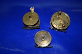 SMALL PLASTIC BOX CONTAINING THREE BRASS FISHING REELS