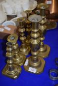 THREE PAIRS OF BRASS CANDLESTICKS