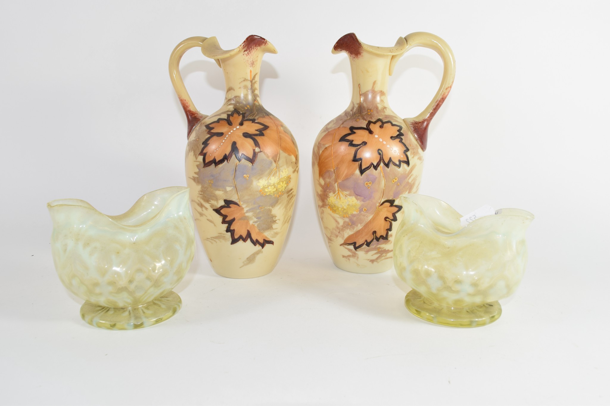 Pair of Vaseline glass vases together with two glass ewers painted with floral decoration, 22cm high