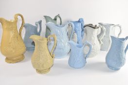 Group of ten relief moulded 19th century pottery jugs by various manufacturers including a jug of