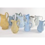 Group of ten relief moulded 19th century pottery jugs by various manufacturers including a jug of