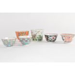 Group of Chinese porcelain tea bowls including a coral ground tea bowl with floral decoration and