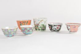 Group of Chinese porcelain tea bowls including a coral ground tea bowl with floral decoration and