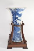 Large flared Chinese porcelain vase decorated with flowers and a landscape scene within a wood and