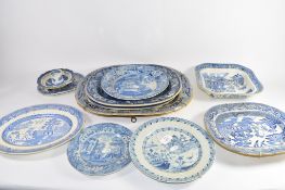 Group of 12 various blue and white platters and plates including a dish in the Gothic ruins pattern,