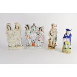 Group of two Staffordshire groups and further Staffordshire model of a young boy with dog and