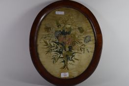 Floral design on silk in oak oval frame, 19th century