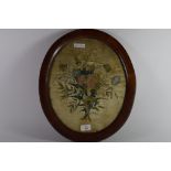 Floral design on silk in oak oval frame, 19th century