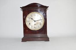 Mahogany cased mantel clock with German movement, circular Arabic chapter ring and bracket feet,