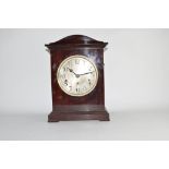 Mahogany cased mantel clock with German movement, circular Arabic chapter ring and bracket feet,