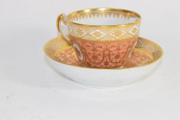 Early 19th century Coalport cup and saucer with a gilt design on salmon ground, pattern number