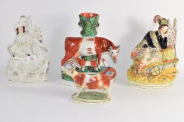 Group of Staffordshire figures including one of a soldier, group of cow and calf and a creamer (4)