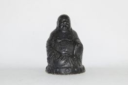 Black painted metal model of a Buddha