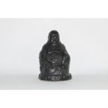 Black painted metal model of a Buddha