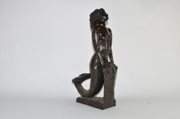 20th century bronzed composition model of a mermaid leaning on a rock, 45cm high