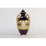 Late 19th century Vienna style porcelain vase and cover, the blue ground with gilt bordered oval