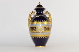 Late 19th century Vienna style porcelain vase and cover, the blue ground with gilt bordered oval