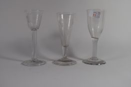 Group of three wine glasses, 18th century, one with air twist (chips to foot), the other two with