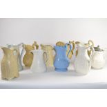 Group of ten 19th century relief moulded pottery jugs by various manufacturers including Copeland