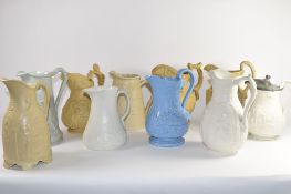 Group of ten 19th century relief moulded pottery jugs by various manufacturers including Copeland