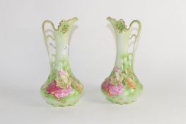 Pair of Continental pottery ewers with a floral design