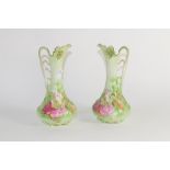 Pair of Continental pottery ewers with a floral design