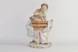 Late 19th century Continental porcelain model of a washer girl on a circular base with tub of