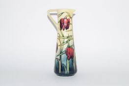 Moorcroft jug in Art Nouveau shape, decorated with the Tulip pattern, signed by Philip Gibson, dated