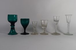 Two 18th century air-twist wine glasses together with two further green coloured wine glasses plus